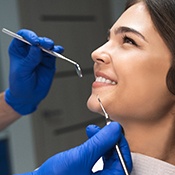 smiling dental patient after getting her dental crown