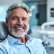 older man smiling in the dentist chair