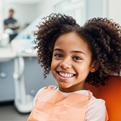 young girl smiling in the dentist chair