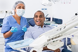 happy dental patient and the assistant